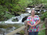 Lori beside the river along the trail to Anna Ruby Falls