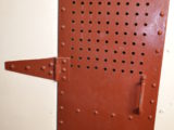 Closed door to one of the cells in "The Hole"